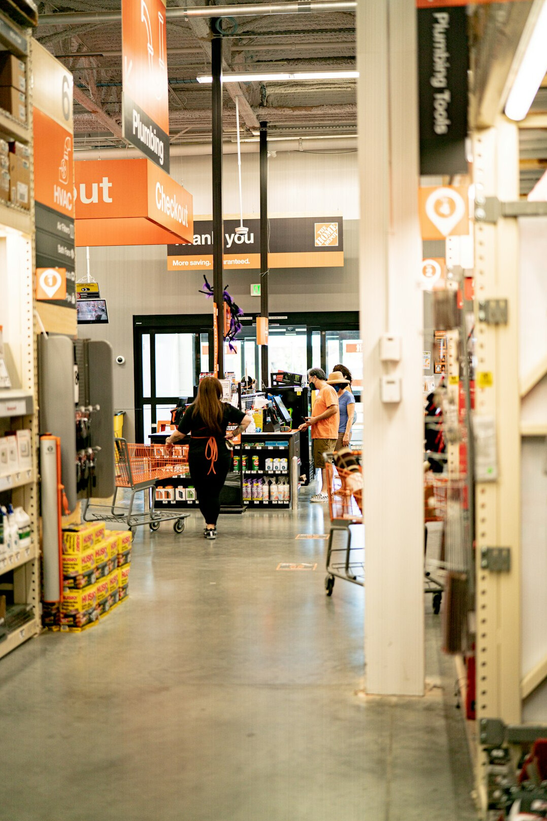 Customers walking through a busy supermarket aisle with motion blur