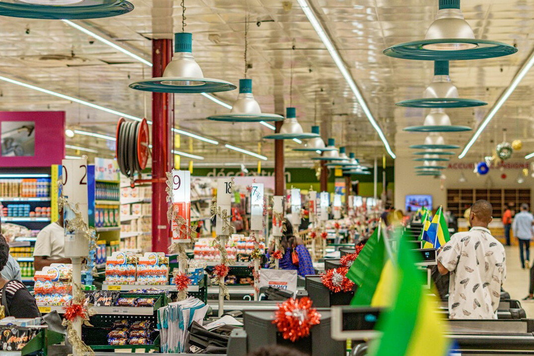 Overhead view of a busy supermarket aisle with shopping carts