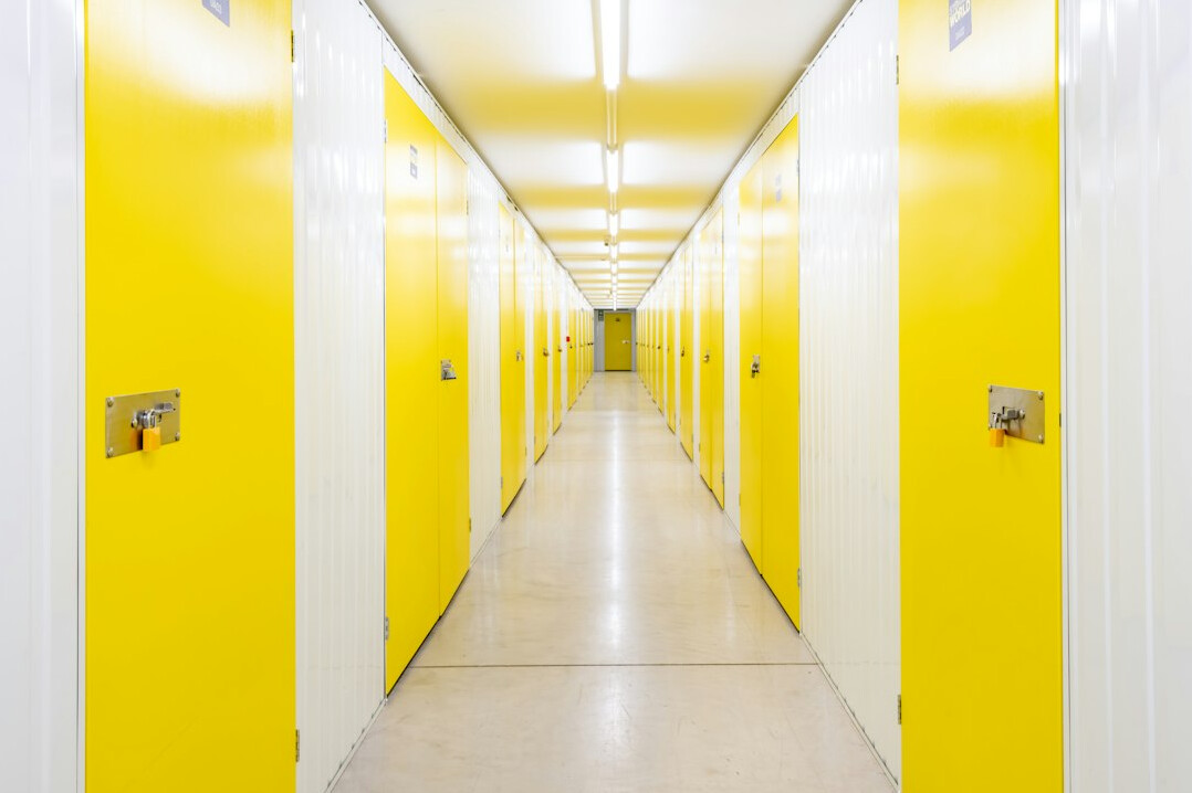 Stockroom corridor with pallets and labeled capacity zones