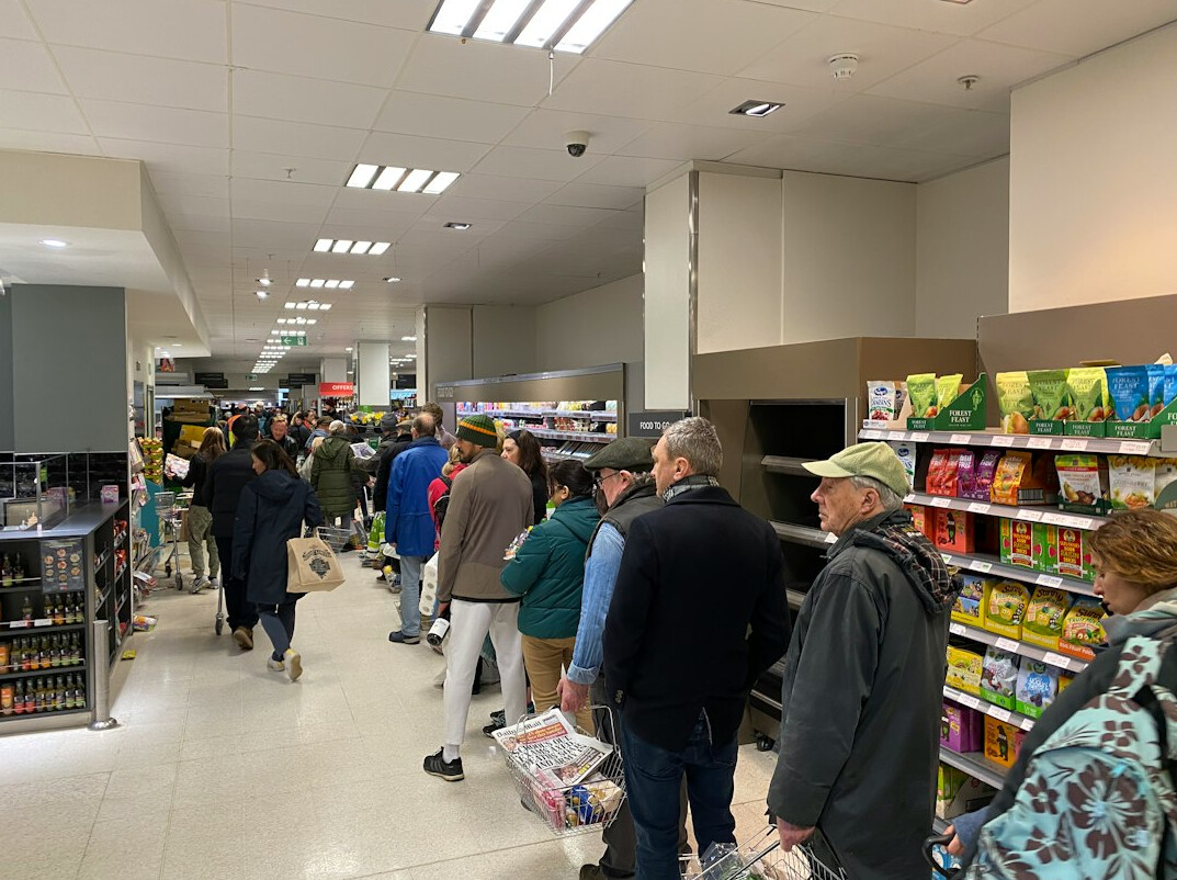 Retail staff gathered for a morning briefing huddle before opening